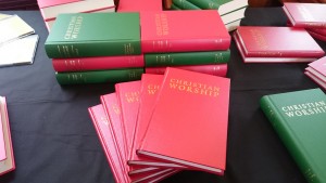 Piles of hymn books, the new edition a lot thinner than the original.