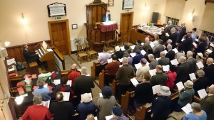 a congregation singing, viewed from above in the gallery, in Ebenezer Chapel, Old Hill